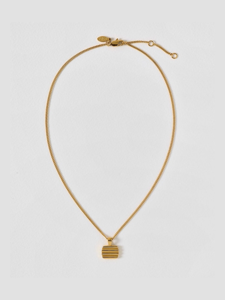 Oliver Bonas Gold Bibi Gold Tone Waterproof Ridged Disc Pendant Necklace - Image 1 of 4 Oliver Bonas Gold Bibi Gold Tone Waterproof Ridged Disc Pendant Necklace - Image 1 of 4
