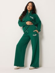 PixieGirl Petite Green Etienne Slogan Wide Leg Joggers - Image 1 of 6