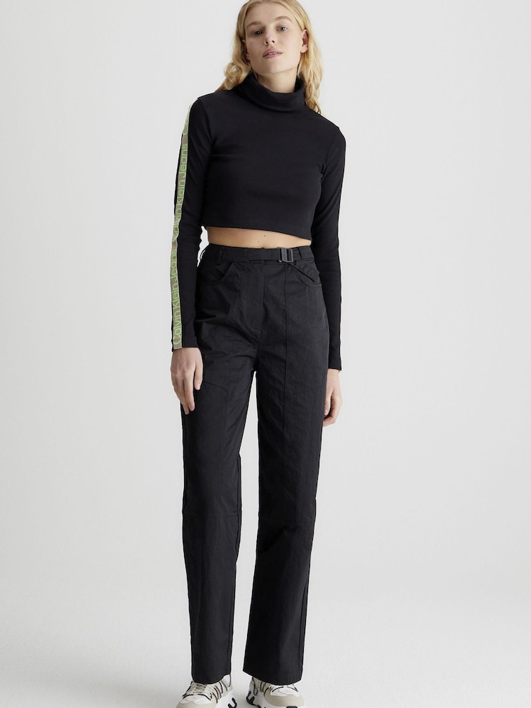 Calvin Klein Jeans Logo Belt High Rise Relaxed Black Joggers - Image 1 of 5 Calvin Klein Jeans Logo Belt High Rise Relaxed Black Joggers - Image 1 of 5