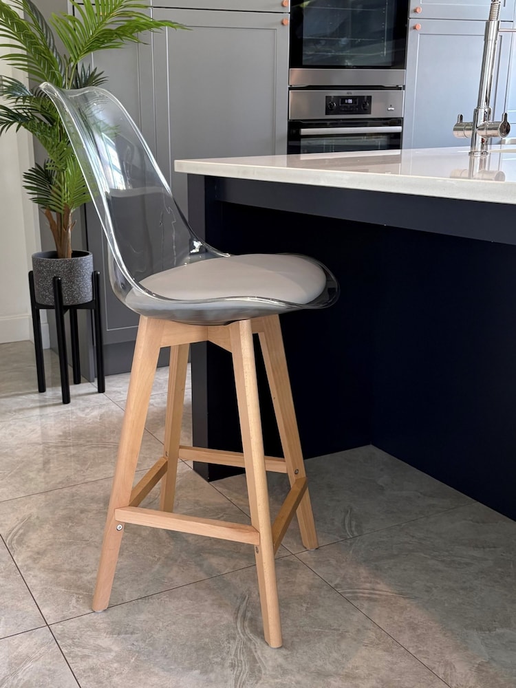 Fusion Living Light Grey Soho Clear Plastic Bar Stool with Light Wood Legs - Image 1 of 5 Fusion Living Light Grey Soho Clear Plastic Bar Stool with Light Wood Legs - Image 1 of 5
