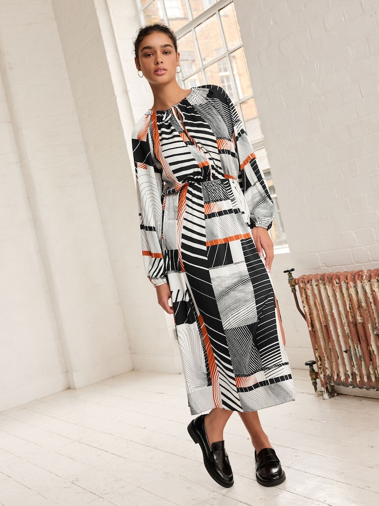 Monochrom/Orange mit abstraktem Print - Langärmliges Midikleid mit Bindeschleife - Bild 1 von 6 Monochrom/Orange mit abstraktem Print - Langärmliges Midikleid mit Bindeschleife - Bild 1 von 6