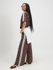 River Island Brown Polka Dot Neoprene Tape Trousers - Image 1 of 4