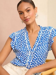 Love & Roses Blue Polka Dot Ruffle Trim V Neck Flutter Sleeve Blouse - Image 1 of 4