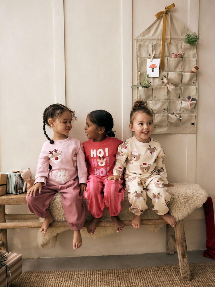 Pink/Cream Christmas 100% Cotton Joggers Pyjamas 3 Pack (9mths-12yrs) - Image 1 of 7 Pink/Cream Christmas 100% Cotton Joggers Pyjamas 3 Pack (9mths-12yrs) - Image 1 of 7