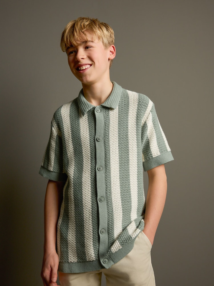 Green/Ecru Vertical Stripe Short Sleeve Button Through Knitted 100% Cotton Polo Shirt (3-16yrs) - Image 1 of 7 Green/Ecru Vertical Stripe Short Sleeve Button Through Knitted 100% Cotton Polo Shirt (3-16yrs) - Image 1 of 7