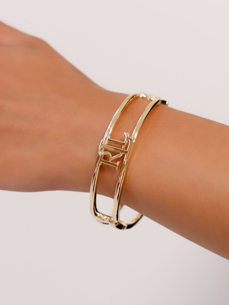 Lauren Ralph Lauren Gold Tone Chambray Logo Bangle - Image 1 of 3 Lauren Ralph Lauren Gold Tone Chambray Logo Bangle - Image 1 of 3