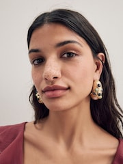 Gold Tone Molten Hoop Earrings - Image 1 of 4
