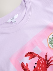 Lilac Purple  Coastal Dinner Front Graphic Relaxed Fit Short Sleeve Seam Detail Skater Style 100% Cotton T-Shirt - Image 7 of 7