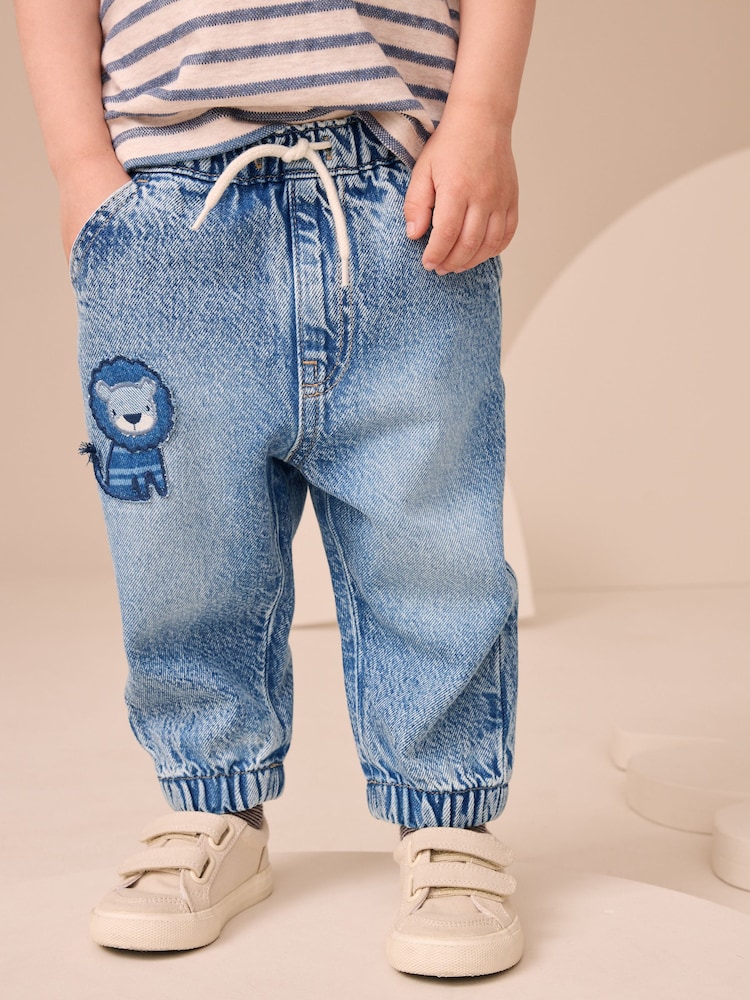 Blue Denim Lion Pull On Cuffed 100% Cotton Jeans (3mths-7yrs) - Image 1 of 8 Blue Denim Lion Pull On Cuffed 100% Cotton Jeans (3mths-7yrs) - Image 1 of 8