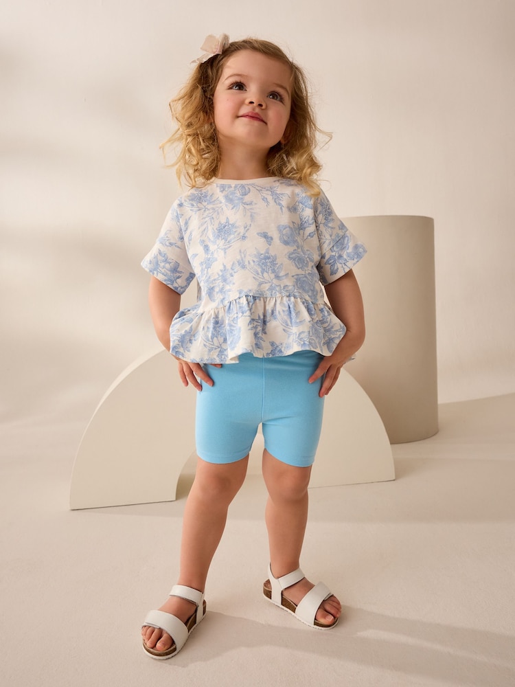 Blau mit floralem Muster - Kurzärmeliges T-Shirt aus 100 % Baumwolle mit Schößchen (3M.–7J.) - Bild 2 von 7 Blau mit floralem Muster - Kurzärmeliges T-Shirt aus 100 % Baumwolle mit Schößchen (3M.–7J.) - Bild 2 von 7