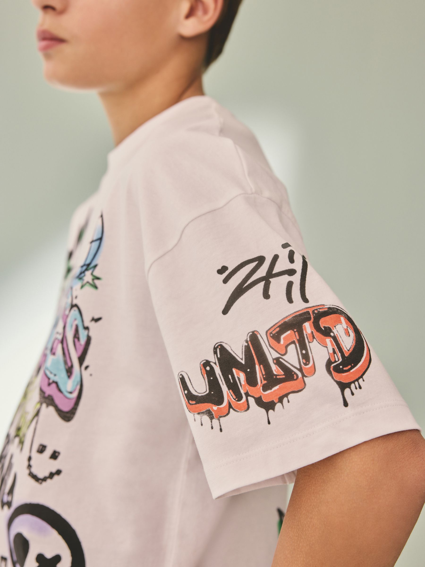 Buy White Graffiti Relaxed Fit Short Sleeve Graphic Print T