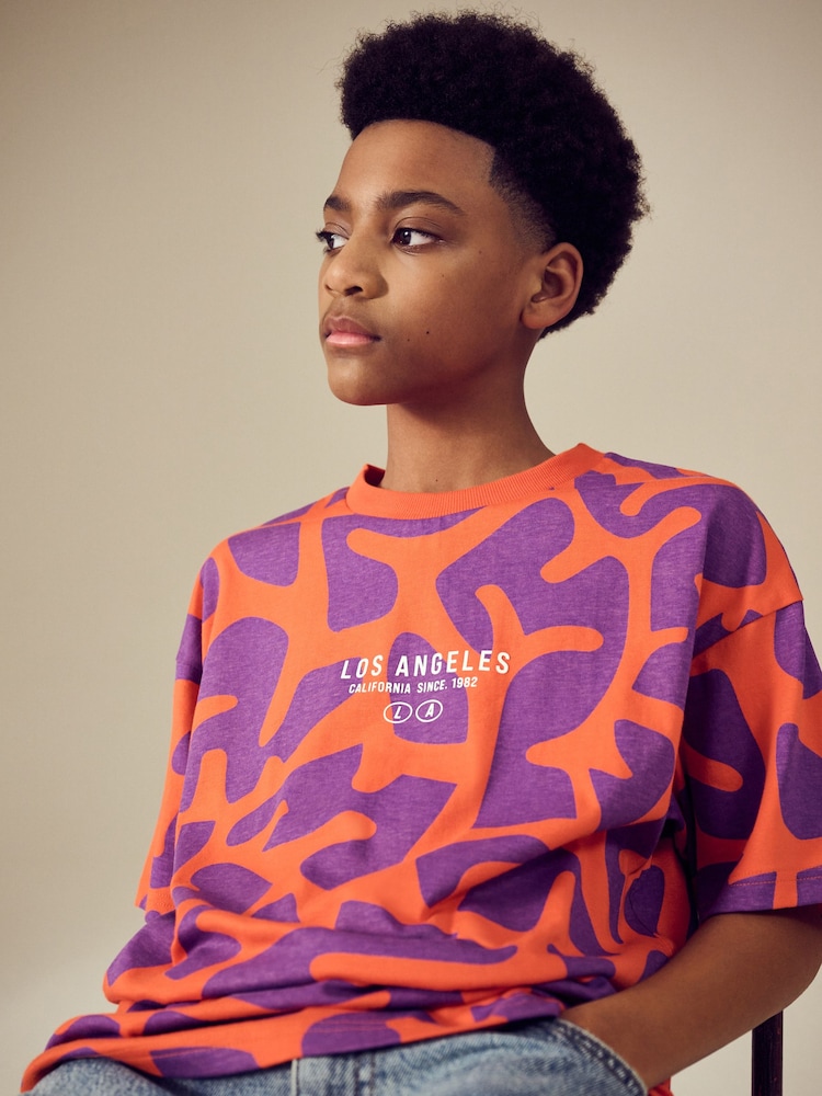 Red/Purple Relaxed Fit Short Sleeve All-Over Print 100% Cotton T-Shirt (3-16yrs) - Image 1 of 4 Red/Purple Relaxed Fit Short Sleeve All-Over Print 100% Cotton T-Shirt (3-16yrs) - Image 1 of 4