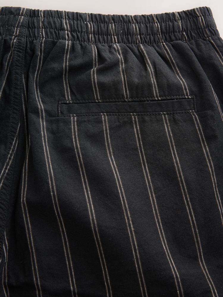 Negro/Blanco - Ajuste tapered regular - Pantalones de lino y algodón a rayas - Imagen 11 de 11 Negro/Blanco - Ajuste tapered regular - Pantalones de lino y algodón a rayas - Imagen 11 de 11