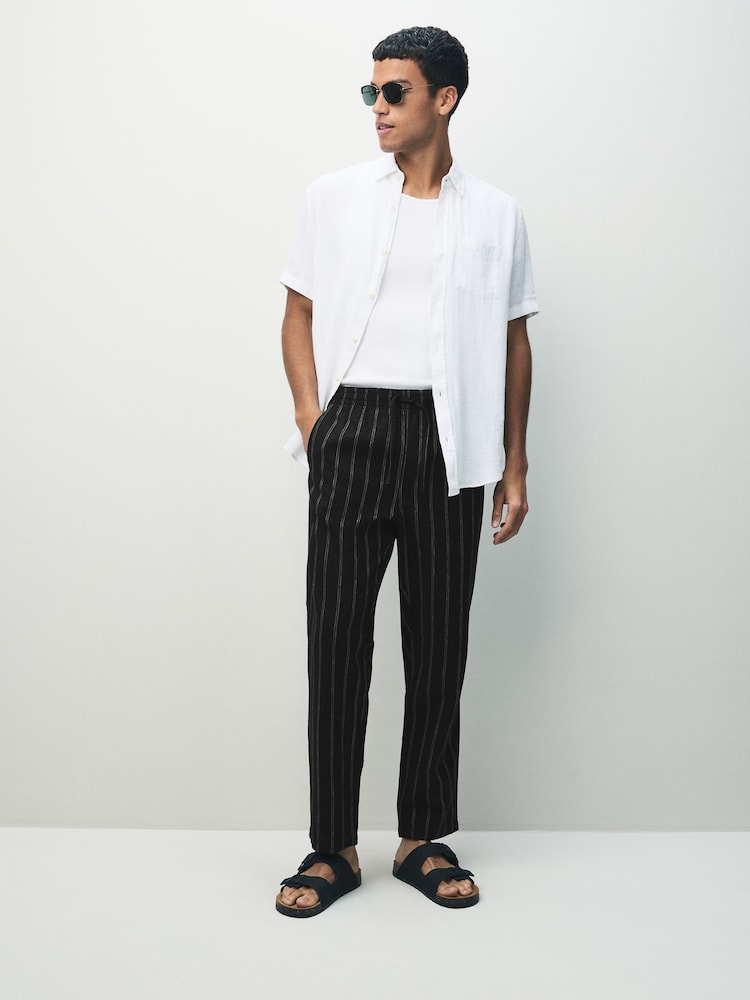 Negro/Blanco - Ajuste tapered regular - Pantalones de lino y algodón a rayas - Imagen 2 de 11 Negro/Blanco - Ajuste tapered regular - Pantalones de lino y algodón a rayas - Imagen 2 de 11
