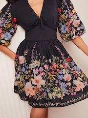 Friends Like These Black Floral Print V-Neck Puff Sleeve Placement Print 100% Cotton Mini Dress - Image 1 of 4