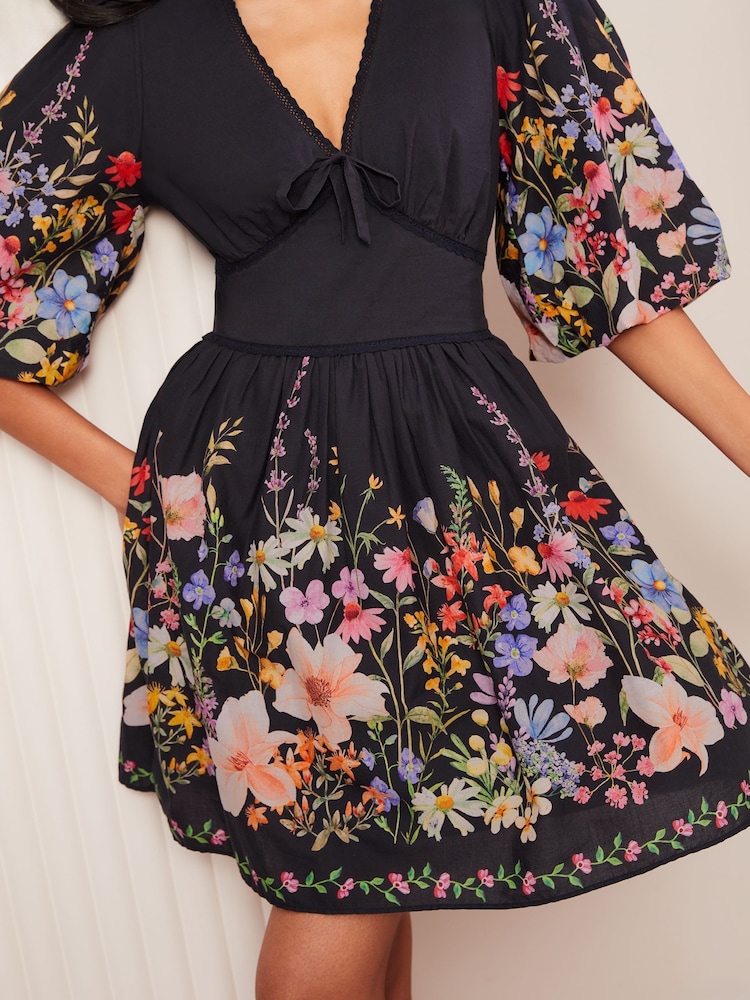Friends Like These Black Floral Print V-Neck Puff Sleeve Placement Print 100% Cotton Mini Dress - Image 1 of 4