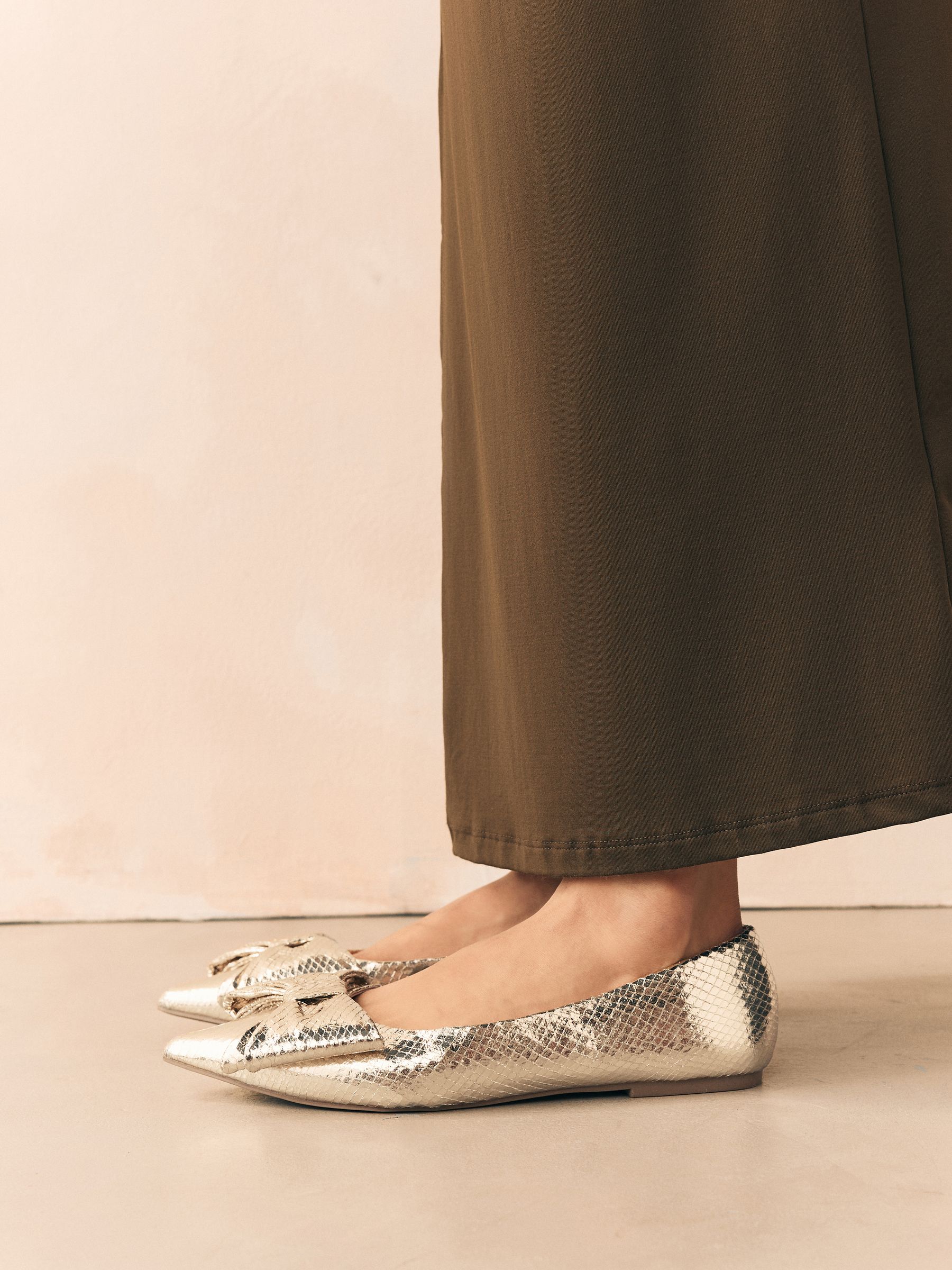 Buy Gold Point Toe Bow Ballerinas from Next USA