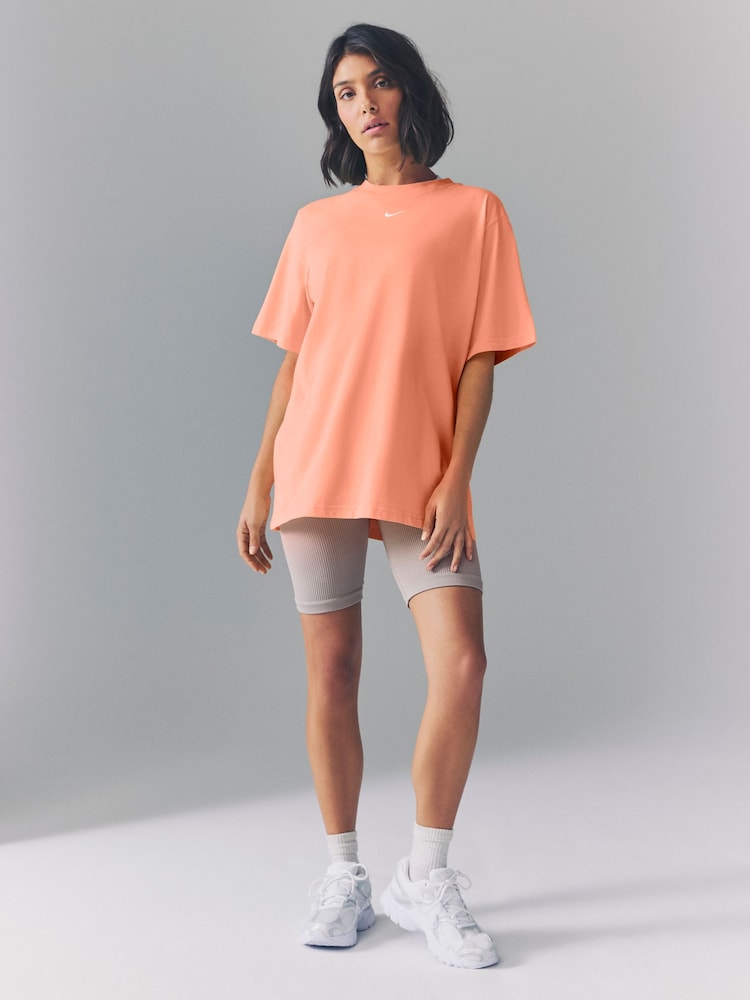 Nike Apricot Orange Oversized Mini Swoosh Sportswear T-Shirt - Image 1 of 5 Nike Apricot Orange Oversized Mini Swoosh Sportswear T-Shirt - Image 1 of 5
