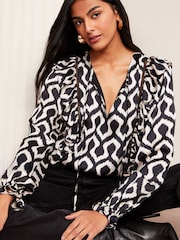 Friends Like These Navy Ikat Long Sleeve Ruffle Trim Tie Front Blouse - Image 1 of 1
