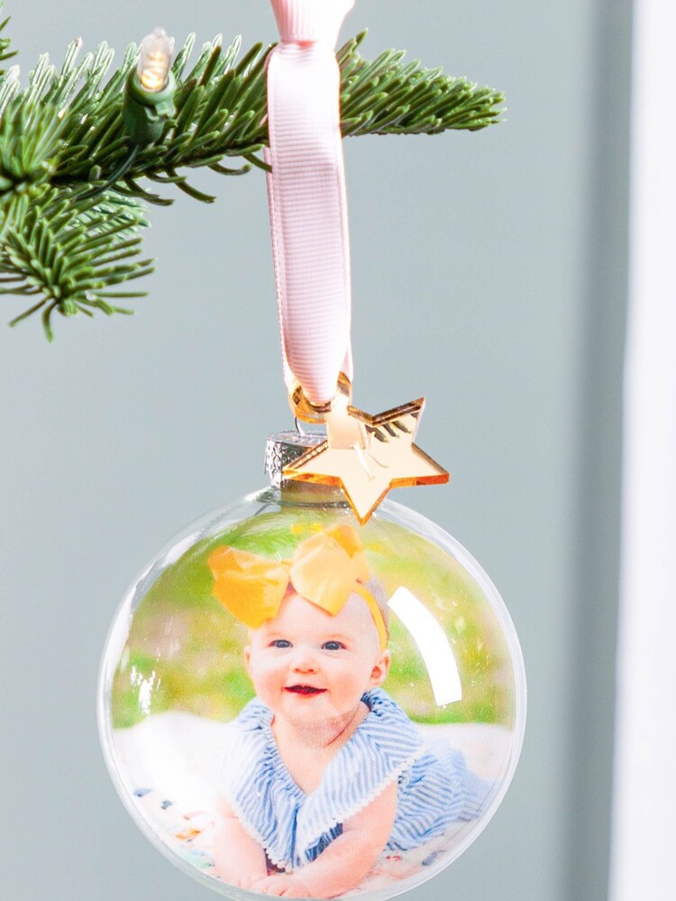Personalised New Baby Photo Christmas Bauble with Gold Star Charm by No Ordinary Gift - Image 1 of 1