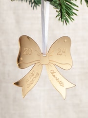 Personalised Metallic Bow First Christmas Decoration by No Ordinary Gift - Image 1 of 2