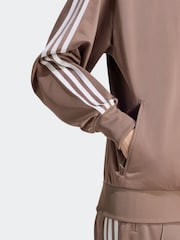 بني - رداء علوي رياضي فضفاض Firebird من adidas originals - صورة 8 من 9