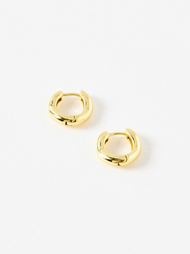 Oliver Bonas Gold Tone Ona Ripple Wave Huggie Hoops Small Earrings - Image 1 of 3 Oliver Bonas Gold Tone Ona Ripple Wave Huggie Hoops Small Earrings - Image 1 of 3