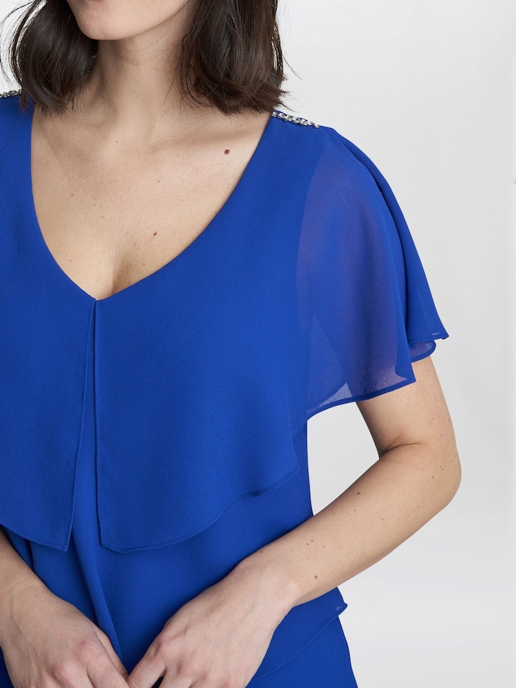 Vestido a media pierna escalonado azul con ribete en los hombros Rebecca de Gina Bacconi - Imagen 4 de 4 Vestido a media pierna escalonado azul con ribete en los hombros Rebecca de Gina Bacconi - Imagen 4 de 4