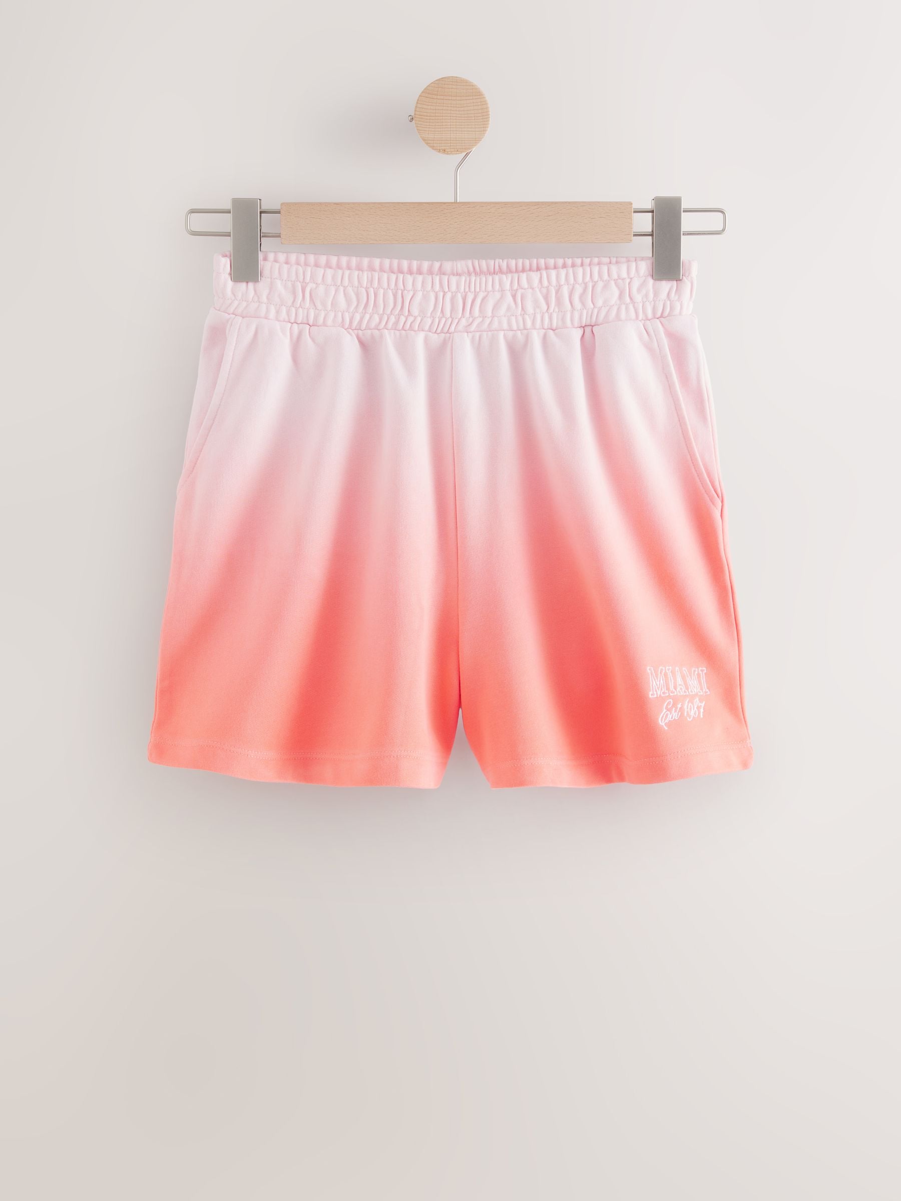Buy Coral Pink Ombre Graphic Shorts from Next Romania