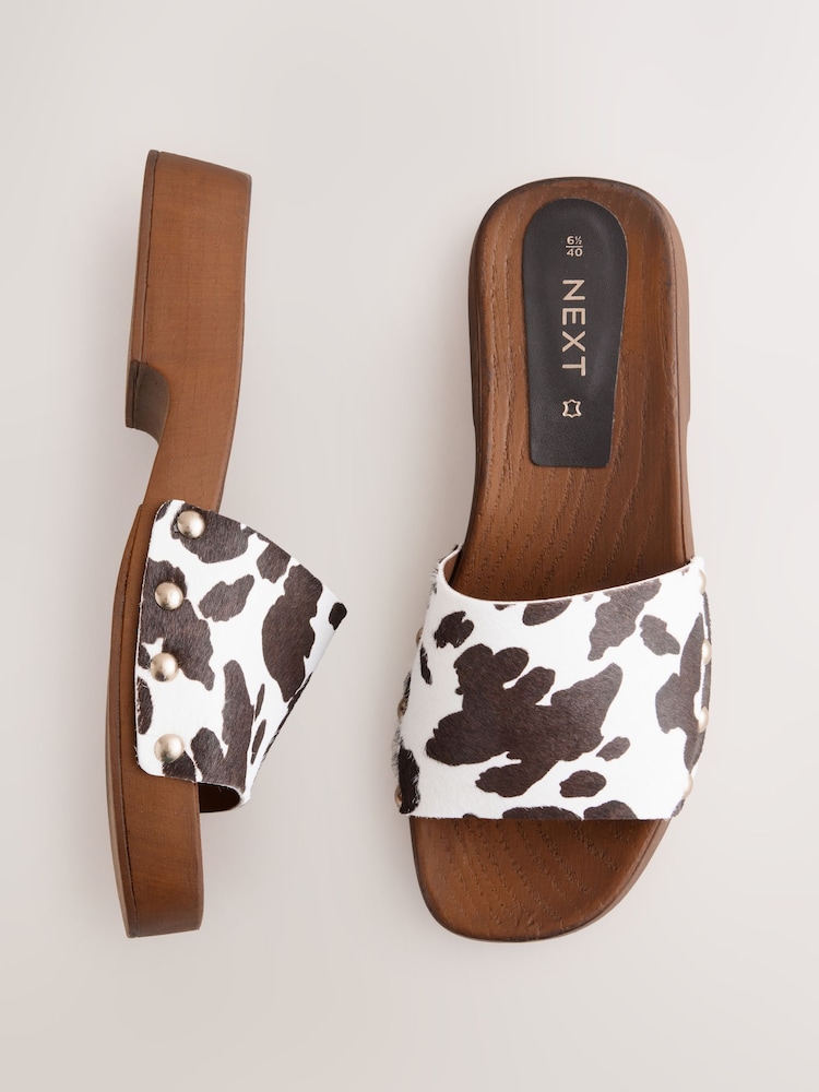 Animal Cow Print Leather - Open Toe Studded Clog Mule Sandals - Image 1 of 12 Animal Cow Print Leather - Open Toe Studded Clog Mule Sandals - Image 1 of 12
