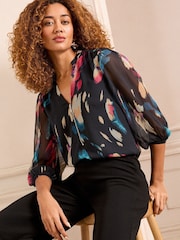 Love & Roses Black Abstract Petite Zip Front Mix Sheer Long Sleeve Length Blouse - Image 1 of 4