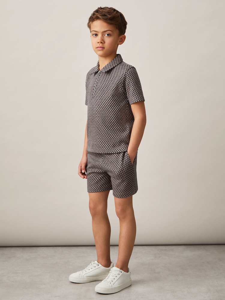 Reiss Tobacco Brown/Navy Baines 9-13 yrs Geometric Jacquard Polo Shirt - Image 1 of 4 Reiss Tobacco Brown/Navy Baines 9-13 yrs Geometric Jacquard Polo Shirt - Image 1 of 4