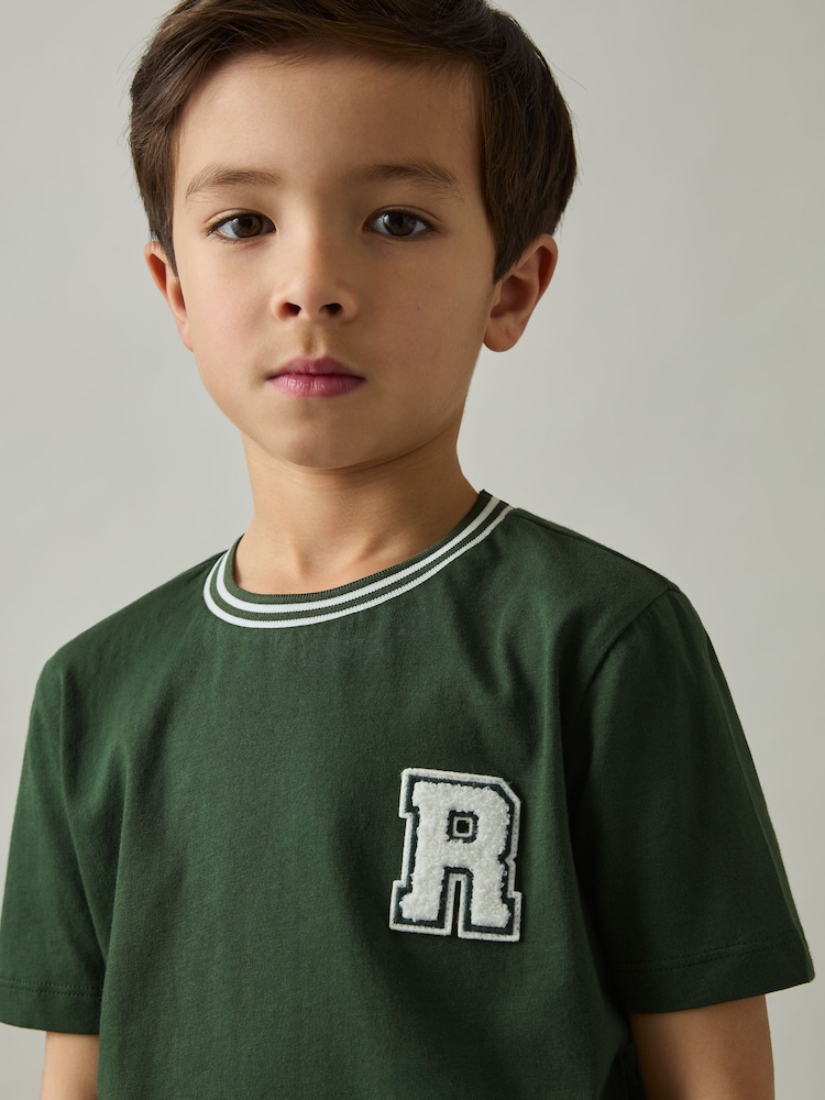 Reiss Green Palmers 9-13 yrs Cotton Letter-Patch T-Shirt - Image 1 of 4 Reiss Green Palmers 9-13 yrs Cotton Letter-Patch T-Shirt - Image 1 of 4