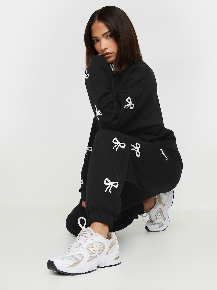 PixieGirl Petite Black Bow Detail Cuffed Joggers - Image 1 of 5