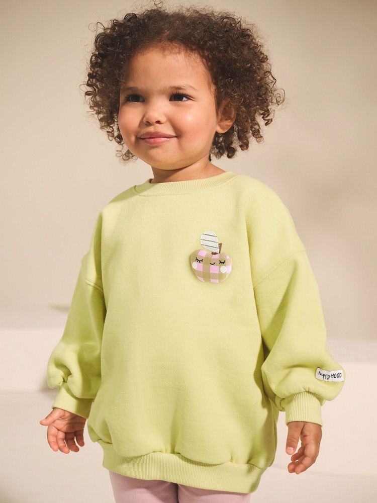 Lime Green Apple Character - سويت شيرت ياقة بحافة مستديرة (3 أشهر- 7 سنوات) - صورة 1 من 9 Lime Green Apple Character - سويت شيرت ياقة بحافة مستديرة (3 أشهر- 7 سنوات) - صورة 1 من 9