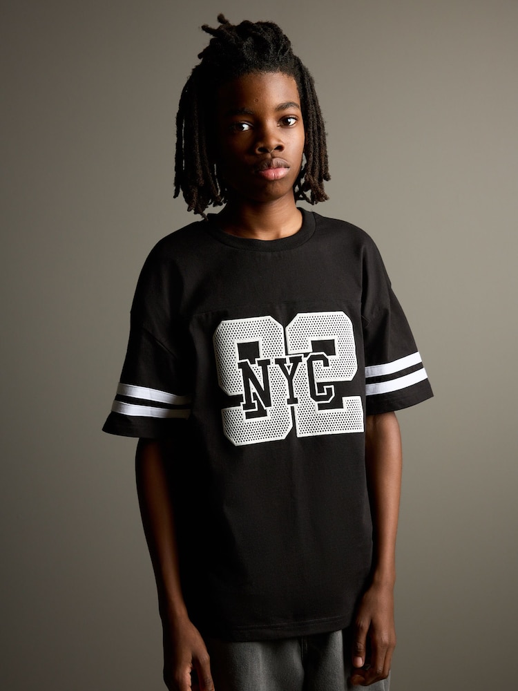 Black Varsity Relaxed Fit Short Sleeve Graphic Print T-Shirt (3-16yrs) - Image 1 of 8 Black Varsity Relaxed Fit Short Sleeve Graphic Print T-Shirt (3-16yrs) - Image 1 of 8