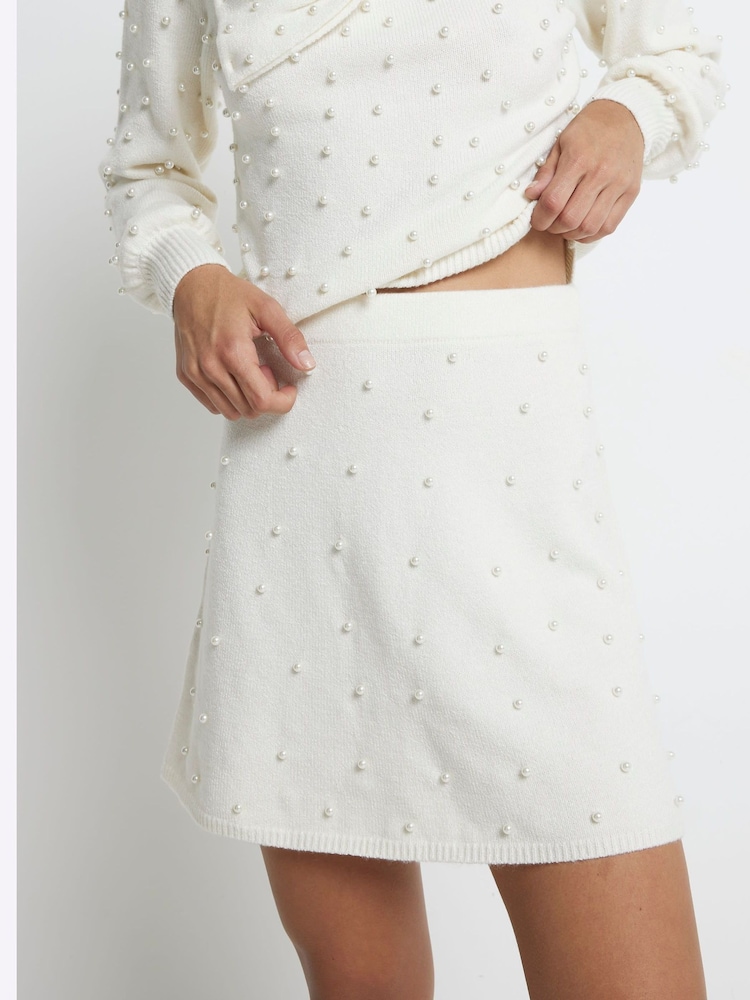 River Island Cream Pearl Detail Flippy Mini Skirt - Image 1 of 5 River Island Cream Pearl Detail Flippy Mini Skirt - Image 1 of 5