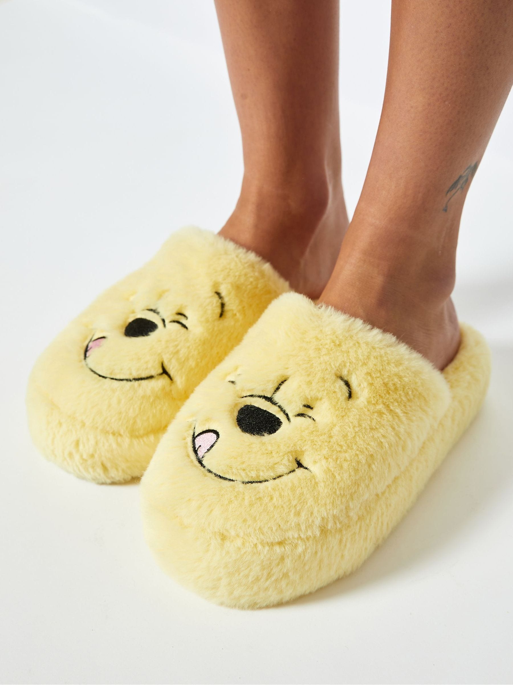 Buy Skinnydip Yellow Skinnydip Disney Winnie The Pooh White Slippers from Next Luxembourg