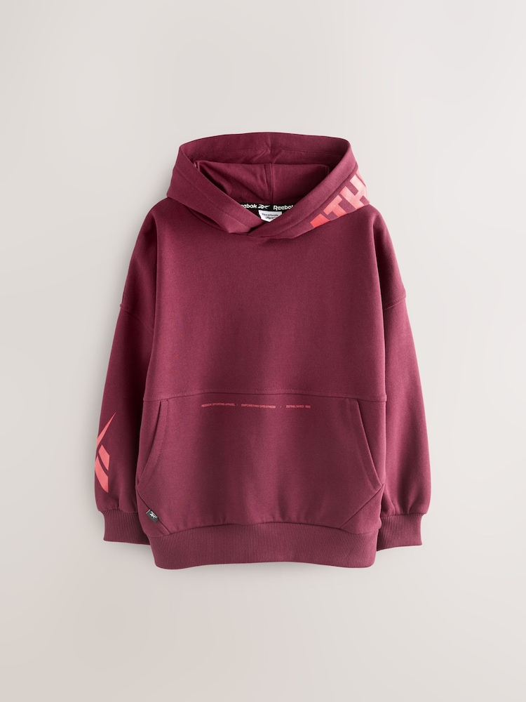 Reebok Overszied Burgundy Red Graphic Print Long Sleeve Cotton Hoodie - Image 1 of 6 Reebok Overszied Burgundy Red Graphic Print Long Sleeve Cotton Hoodie - Image 1 of 6