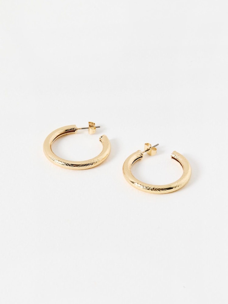 Oliver Bonas Gold Tone Ziada Textured Small Hoops - Image 1 of 3 Oliver Bonas Gold Tone Ziada Textured Small Hoops - Image 1 of 3