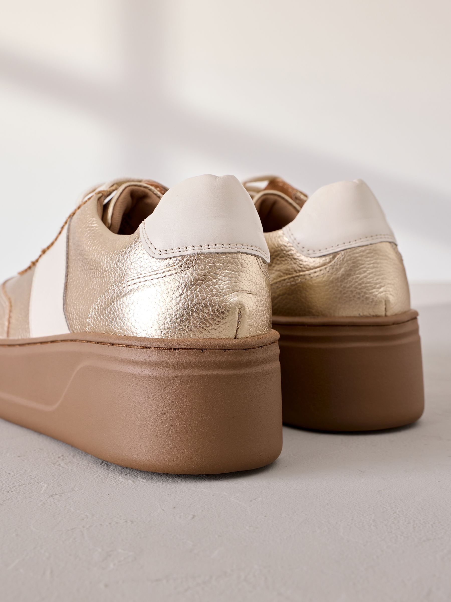 Buy Gold Signature Leather Chunky Wedge Platform Trainers from