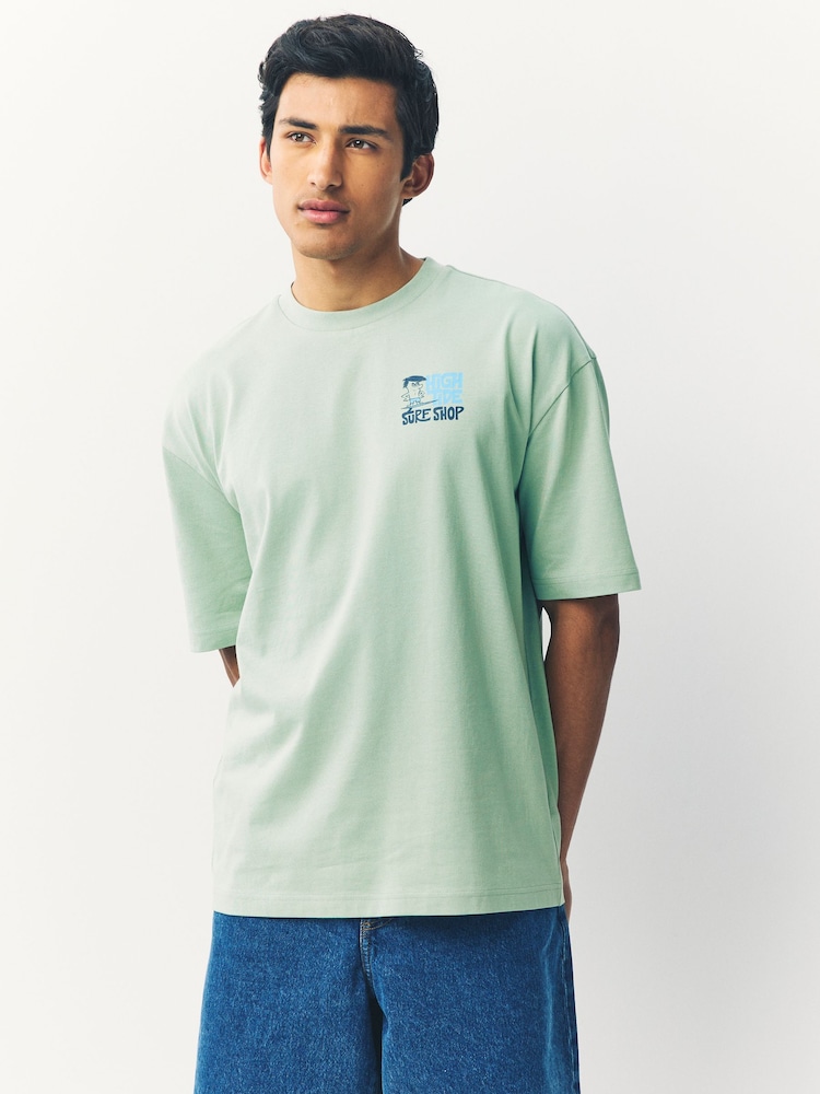Green Surf Character Regular Fit Graphic Print T-Shirt - Image 1 of 8 Green Surf Character Regular Fit Graphic Print T-Shirt - Image 1 of 8