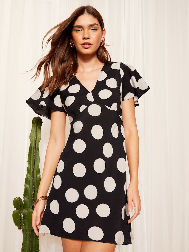 Friends Like These Black/White Flutter Sleeve Tie Back Mini Dress - Image 1 of 4
