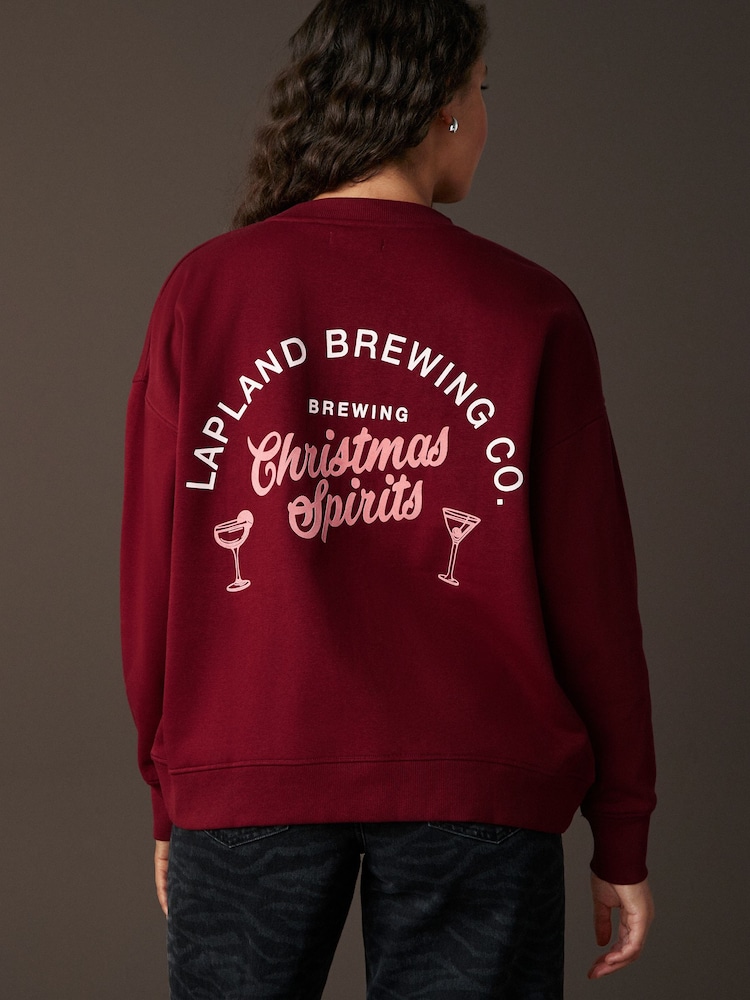 Burgundy Red/Berry Festive Spirits Christmas Lapland Brewing Co Fun Graphic Crew Neck Sweatshirt - Image 1 of 8