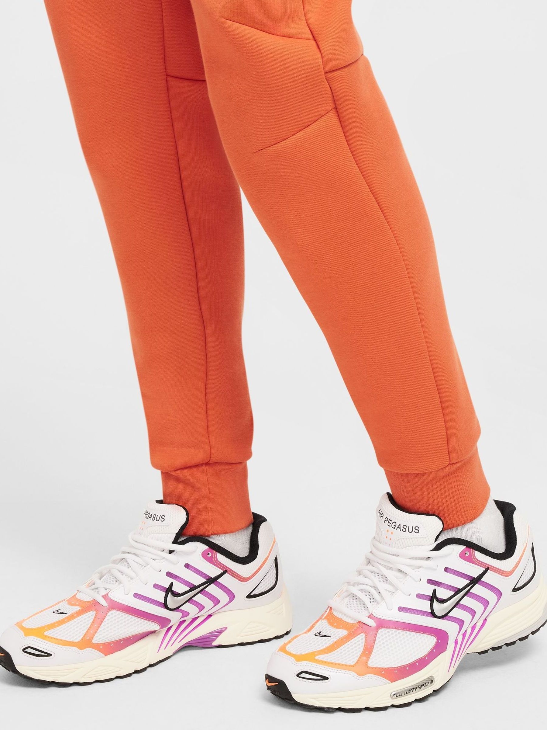 nike women's sportswear neon swoosh fleece pants orange