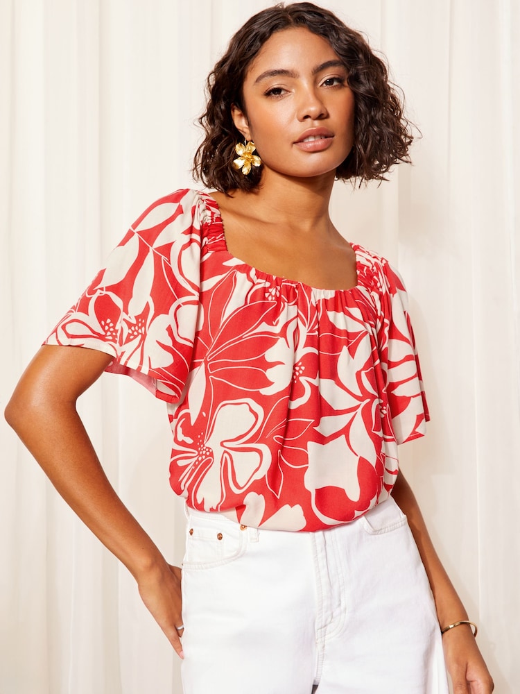 Friends Like These Red Floral Bardot Neck Flutter Sleeve Blouse - Image 1 of 4 Friends Like These Red Floral Bardot Neck Flutter Sleeve Blouse - Image 1 of 4