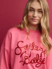 Bright Pink Christmas Santa Baby Bow Graphic Crew Neck Sweatshirt - Image 1 of 7