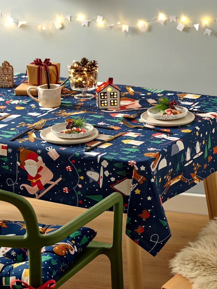 Catherine Lansfield Blue Santas Christmas Wonderland Wipeable 100% Cotton Table Cloth - Image 1 of 3
