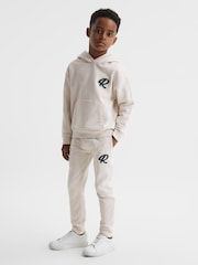Reiss Cream Toby Garment Dyed Logo Joggers - Image 1 of 6