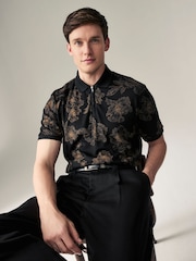 Schwarz/Blumenmuster - Signature Polo-Shirt aus Modal - Bild 1 von 8